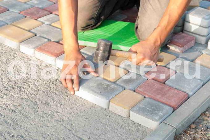 Paving tiles with their hands