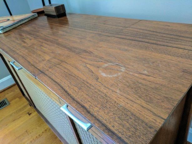 Light spots on wooden furniture from contact with moisture lacquer surface.