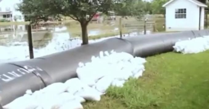 The pipe is further reinforced with sandbags.