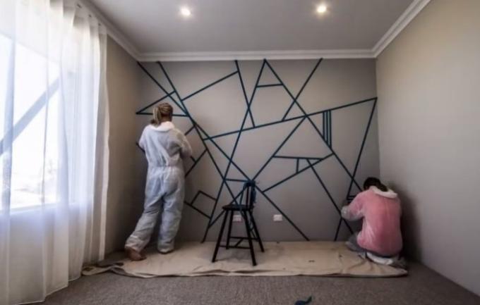 Two friends have used masking tape to transform the room.