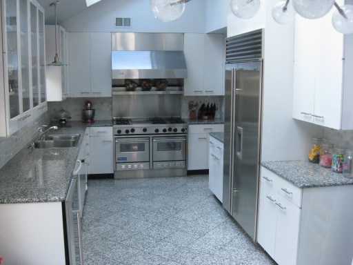 The photo shows a classic design option: a gray kitchen and white furniture.
