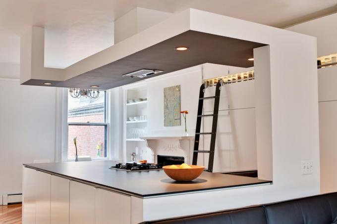 Plasterboard transitions, as in the photo, are often used to enhance zoning in kitchens combined with other rooms