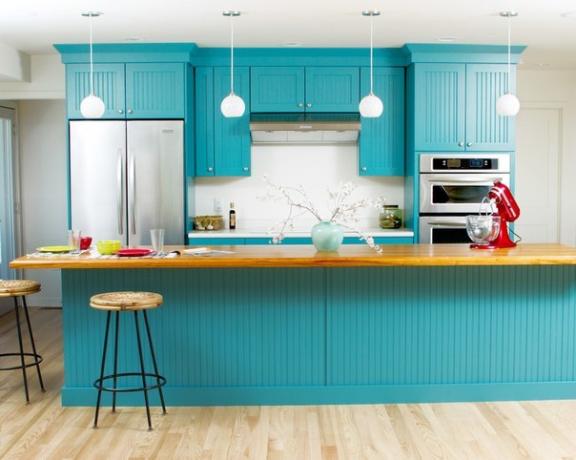 Kitchen set in turquoise color combined with light walls and floor