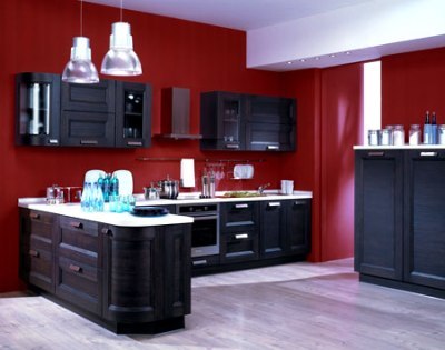 The combination of brown in the interior of the kitchen with white and rich red