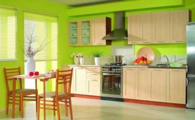 The combination of light green color in the interior of the kitchen with contrasting red details