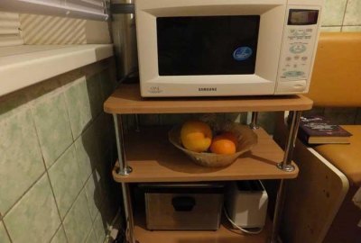 The top shelf can be occupied by a microwave