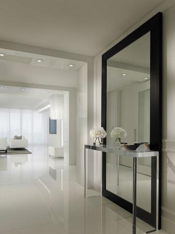 The use of full-height mirrors can add light and volume to the room.
