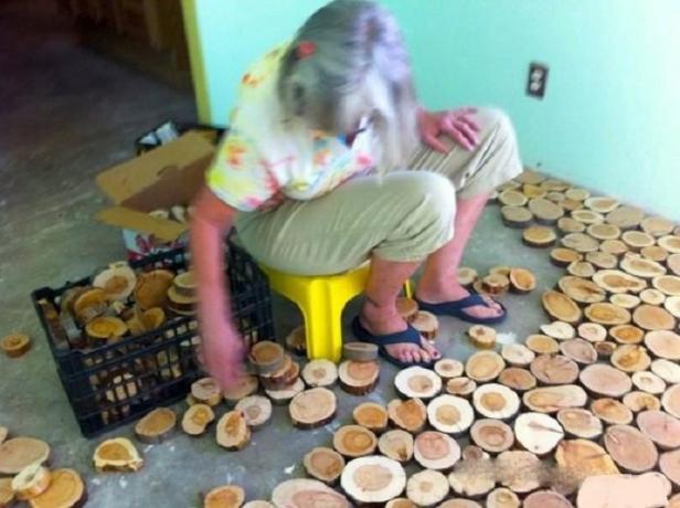 Craftsman sawed pile of wooden rings and fashioned floor is not worse than the famous designers